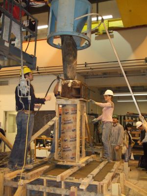 Students pouring concrete in the CEE structures laboratory