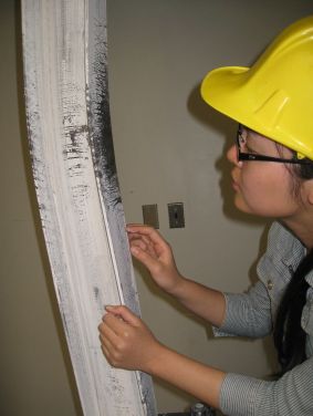 Lin Zhu CEE UG student researcher observing a column test in 502 Davis