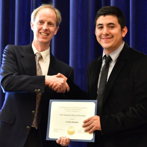 Chair Harley presents the Olsen Scholarship to Cristian Banuelos