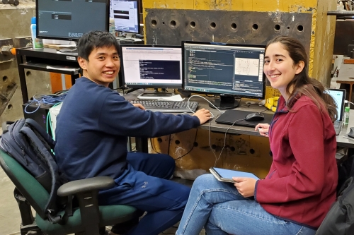 Ph.D. students Camila and Mao test the behavior of isolated bridges using hybrid simulation in the Structures Lab (Photo Credit: Tracy Becker).
